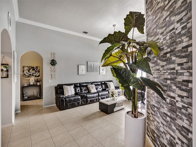 tiled living room featuring a textured ceiling and crown molding