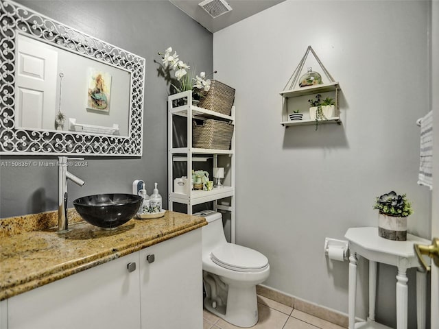 bathroom featuring toilet, tile floors, and large vanity