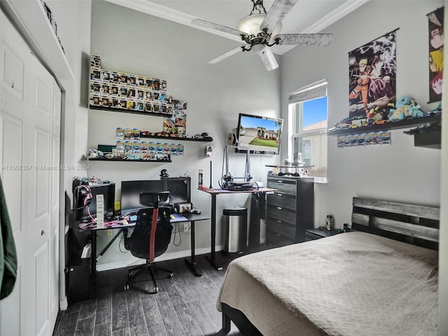 bedroom with a closet, dark hardwood / wood-style floors, ceiling fan, and ornamental molding