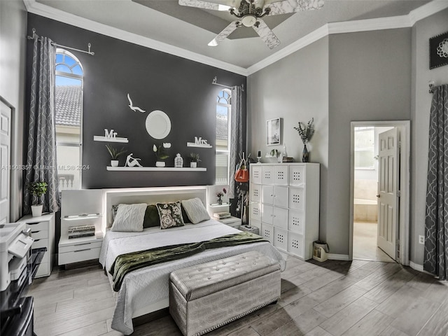 bedroom featuring light hardwood / wood-style flooring, ensuite bathroom, ornamental molding, and ceiling fan