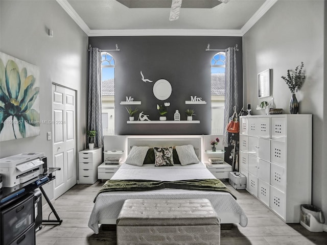 bedroom with multiple windows, ornamental molding, and light wood-type flooring