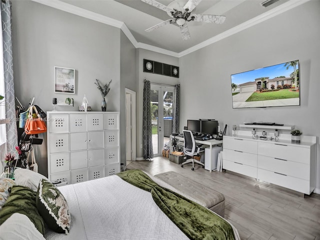 bedroom with light hardwood / wood-style flooring, ceiling fan, and crown molding