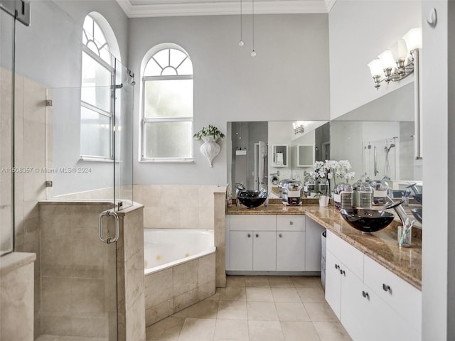 bathroom featuring shower with separate bathtub, tile floors, large vanity, and ornamental molding