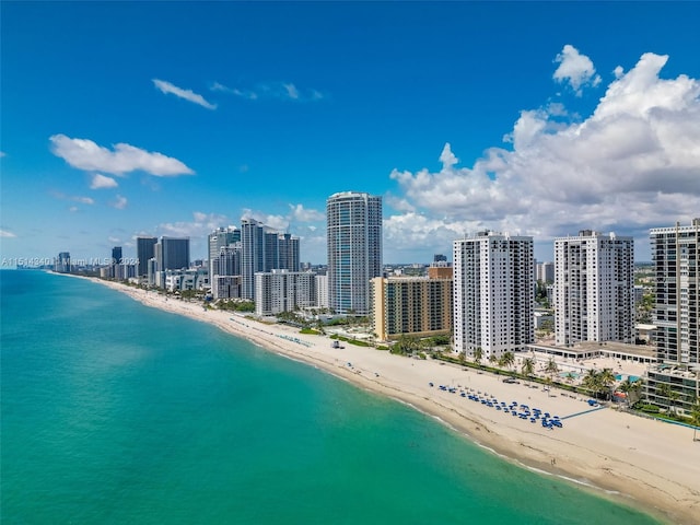 bird's eye view featuring a view of the beach and a water view