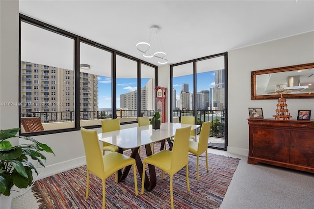 dining room with floor to ceiling windows, a chandelier, and a wealth of natural light