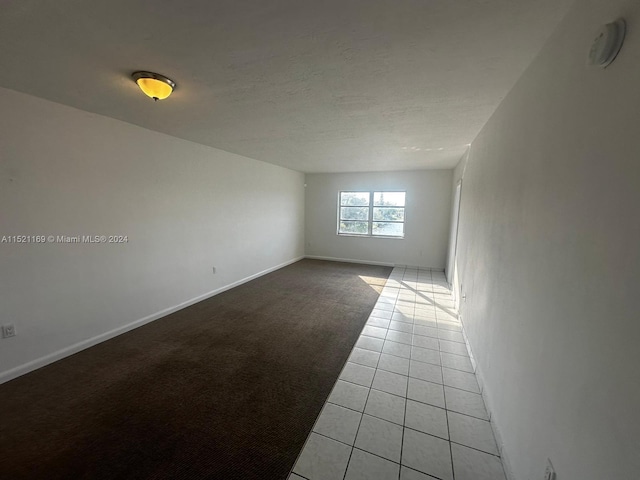 spare room with light colored carpet