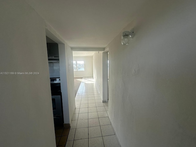 hall featuring light tile flooring