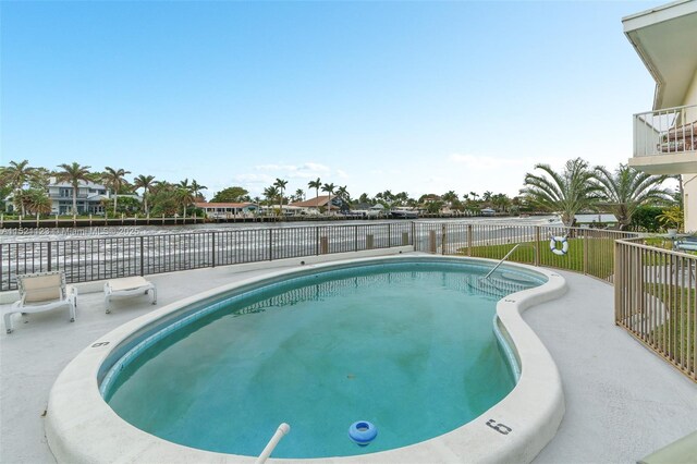 view of pool featuring a water view