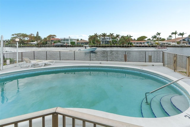 view of swimming pool featuring a water view