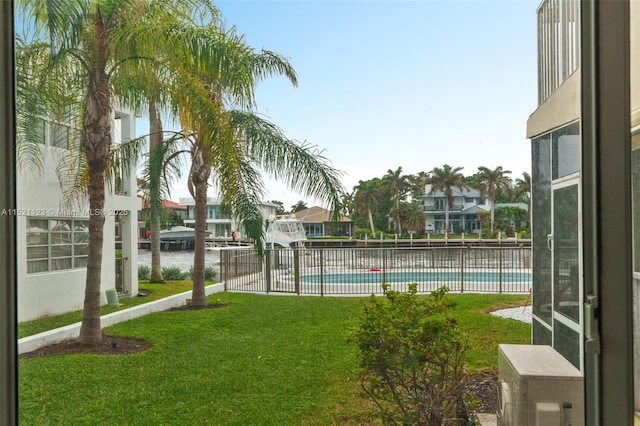 view of pool featuring a yard and a water view