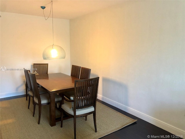 dining room with dark hardwood / wood-style flooring