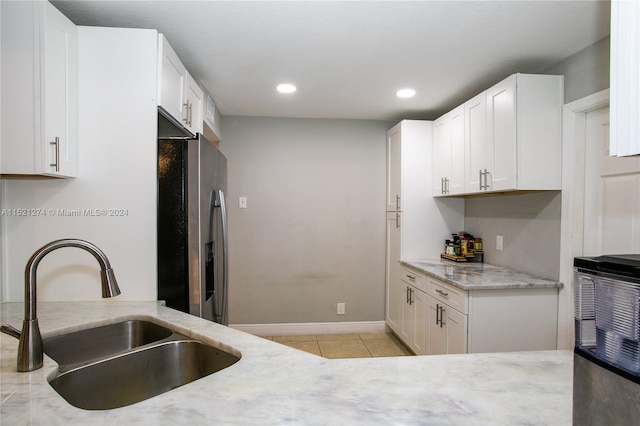 kitchen featuring white cabinetry, stainless steel refrigerator with ice dispenser, and sink