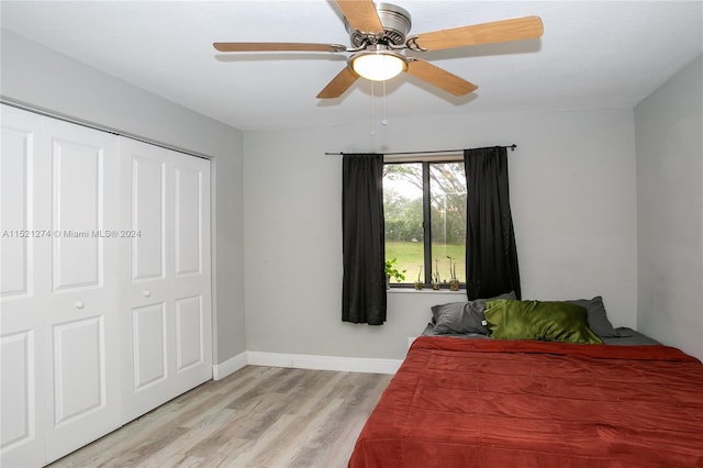 bedroom with a closet, ceiling fan, and light hardwood / wood-style flooring