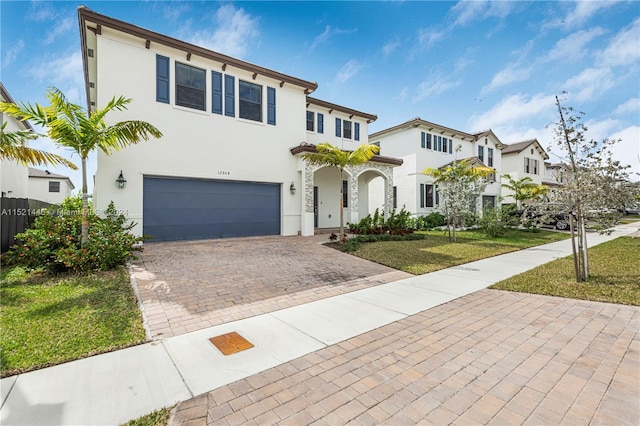 mediterranean / spanish-style home with a front lawn and a garage