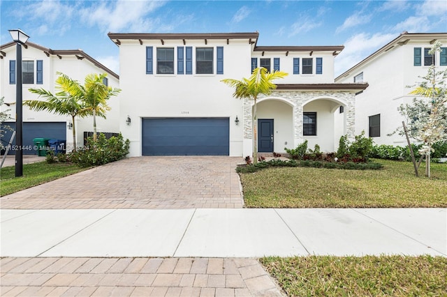 view of front of home with a front yard and a garage