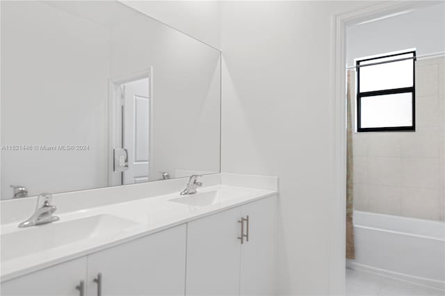 bathroom with tile patterned flooring, vanity, and tiled shower / bath combo