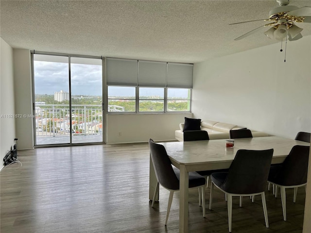 dining area featuring ceiling fan, light hardwood / wood-style flooring, and a textured ceiling