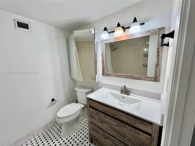 bathroom with vanity, tile flooring, and toilet