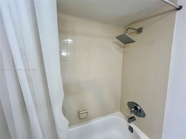 bathroom with shower / bath combination with curtain