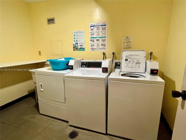 laundry room with tile flooring and washer and dryer