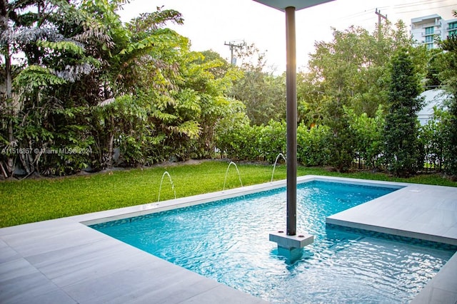 view of pool featuring a lawn, a patio, and pool water feature