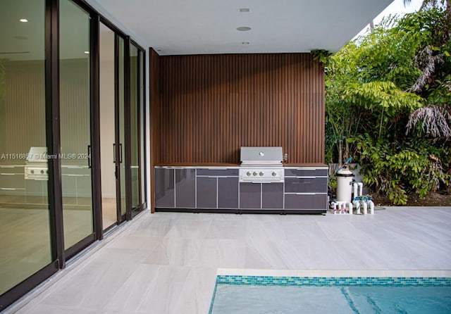 view of patio / terrace featuring grilling area and a swimming pool