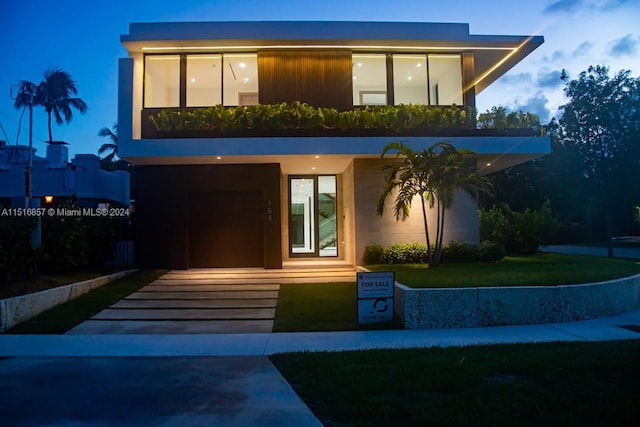 contemporary home with a front lawn