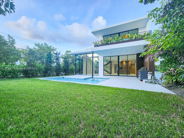 back of house featuring a patio, a yard, a balcony, and pool water feature