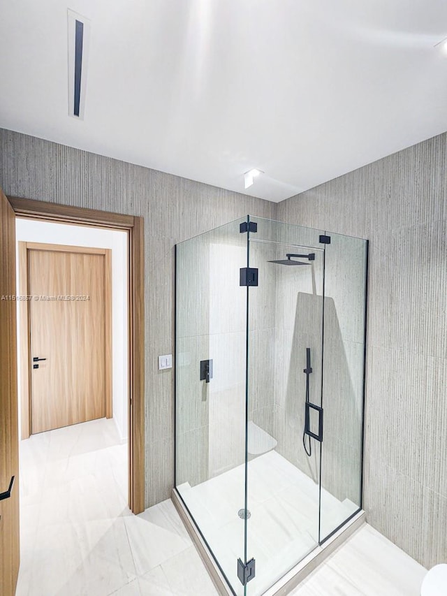 bathroom featuring a shower with shower door