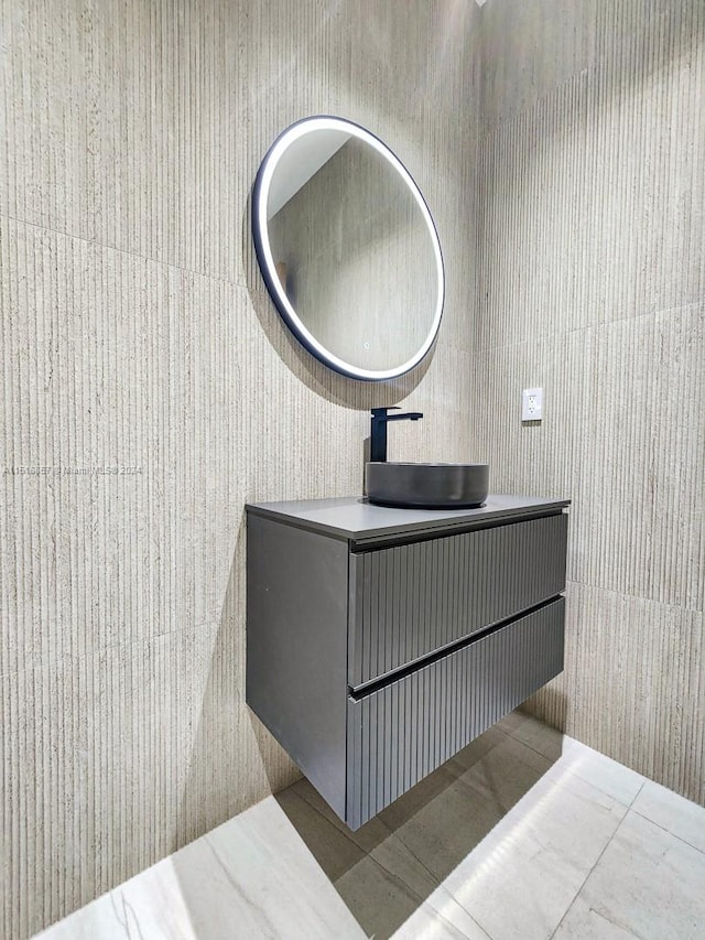 bathroom with vanity, tile walls, and tile patterned flooring