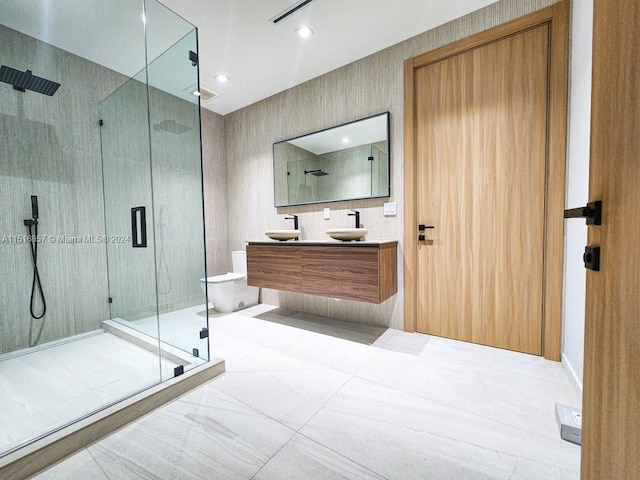 bathroom featuring vanity and a shower with door