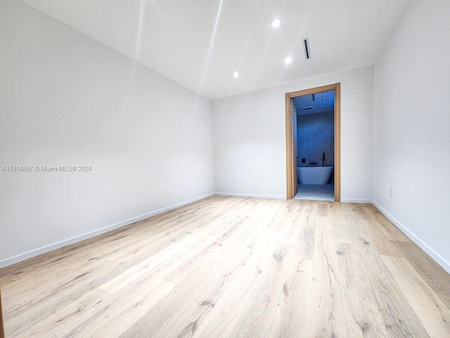 spare room featuring light hardwood / wood-style floors