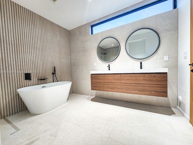 bathroom featuring vanity, a bathtub, and tile walls