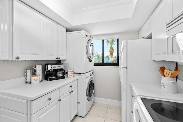 washroom with crown molding, light tile floors, and stacked washer and dryer