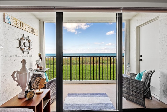 doorway to outside featuring a water view and a wealth of natural light