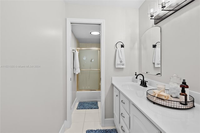 bathroom featuring enclosed tub / shower combo, large vanity, and tile floors