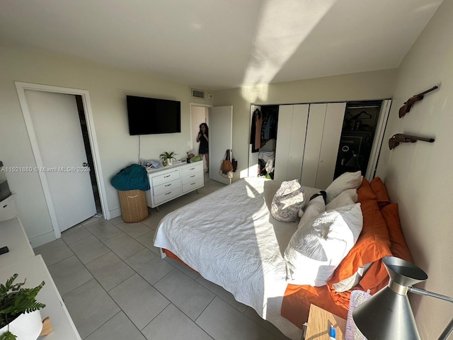 tiled bedroom with a closet