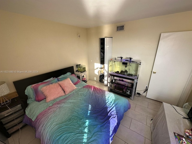 bedroom featuring light tile floors