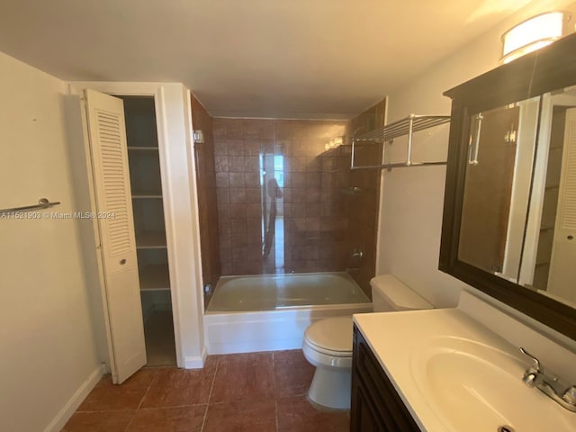 full bathroom with vanity, tiled shower / bath combo, tile flooring, and toilet