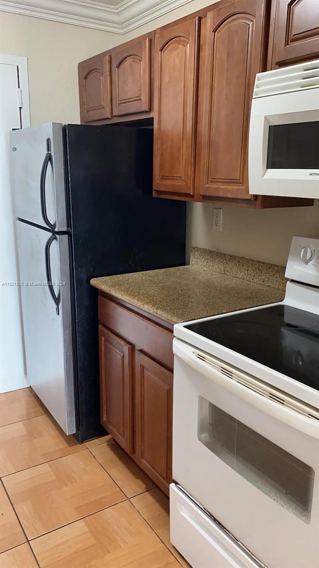 kitchen with white appliances and crown molding