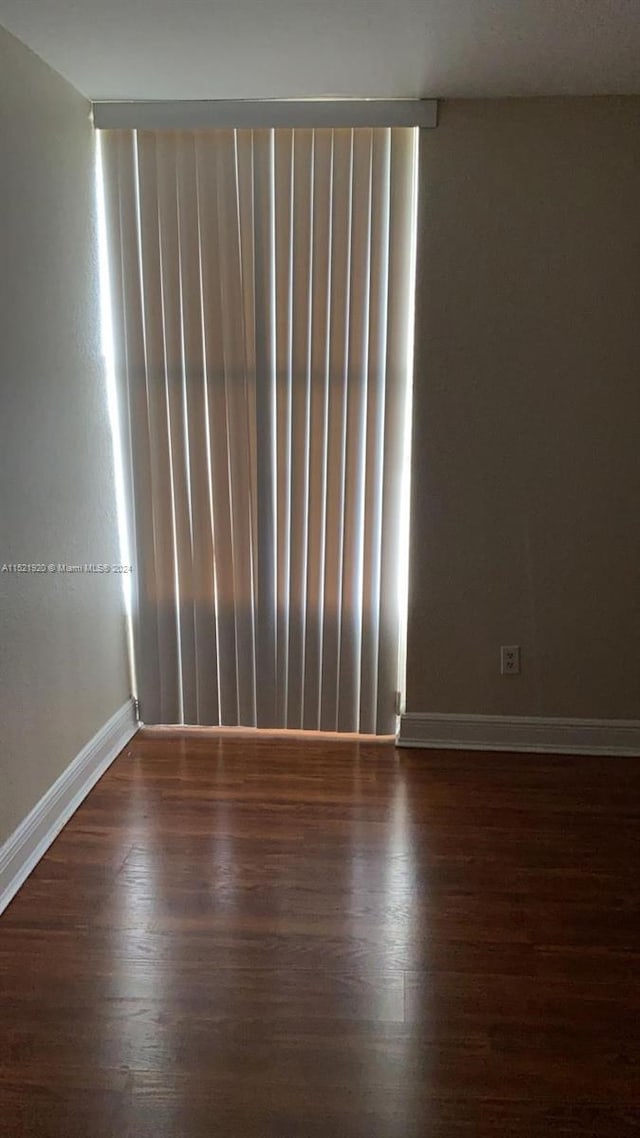 spare room featuring dark hardwood / wood-style floors