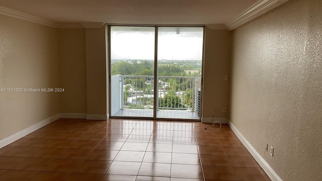 unfurnished room featuring light tile floors and ornamental molding