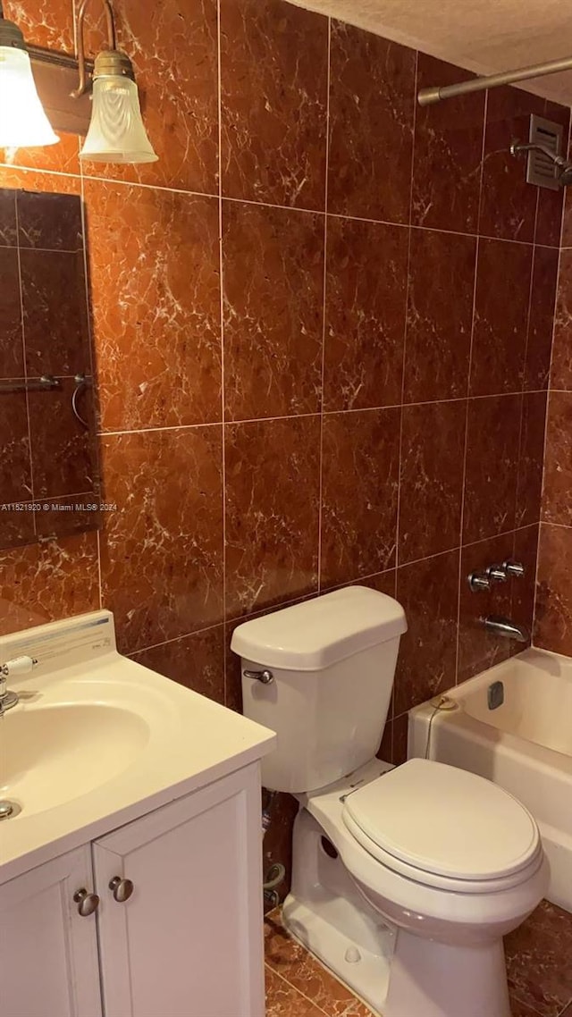 full bathroom featuring tile walls, toilet, shower / bathtub combination, and tile flooring