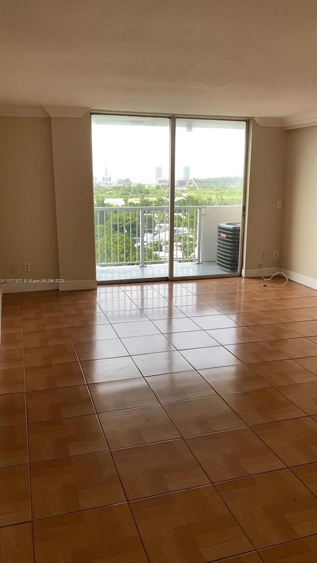 tiled empty room featuring expansive windows