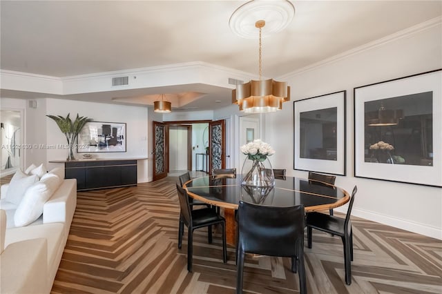 dining area with parquet flooring and crown molding