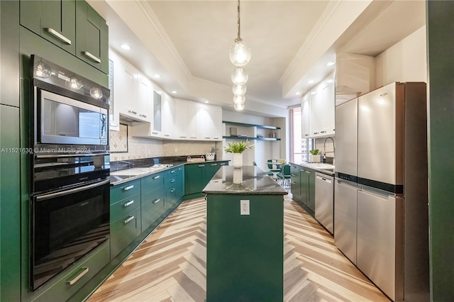 kitchen with stainless steel appliances, white cabinetry, light parquet flooring, and a kitchen island