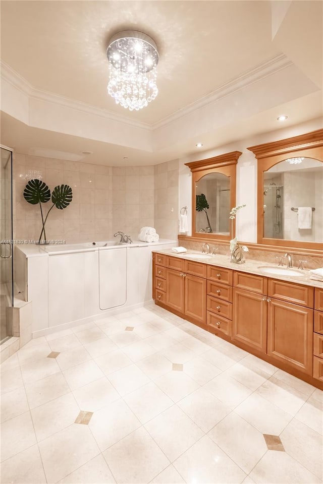 bathroom featuring crown molding, vanity, separate shower and tub, and a tray ceiling