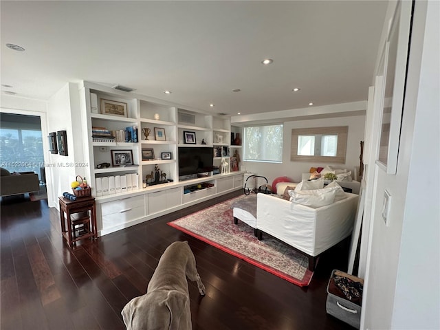 living room featuring dark hardwood / wood-style floors and built in features