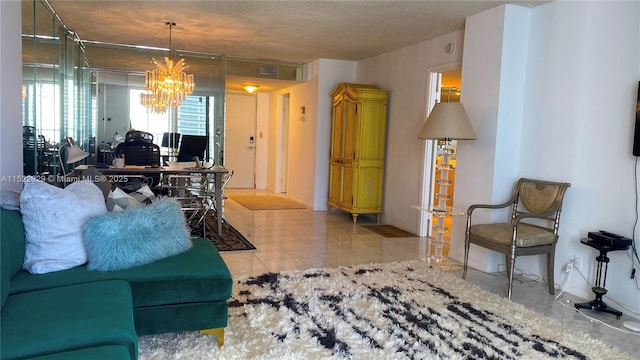 living room with a textured ceiling, light tile patterned floors, and a notable chandelier