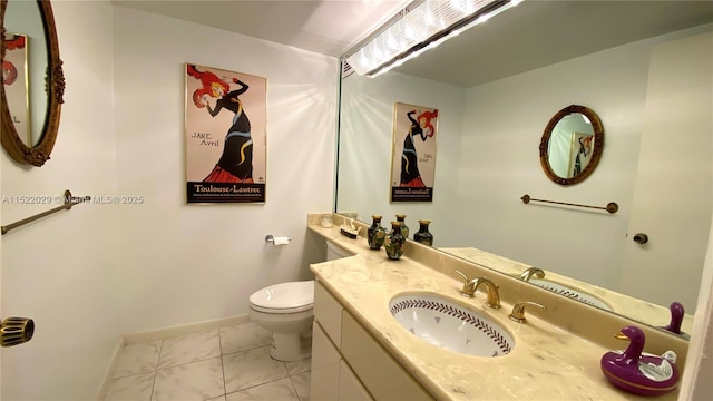 bathroom with toilet and vanity